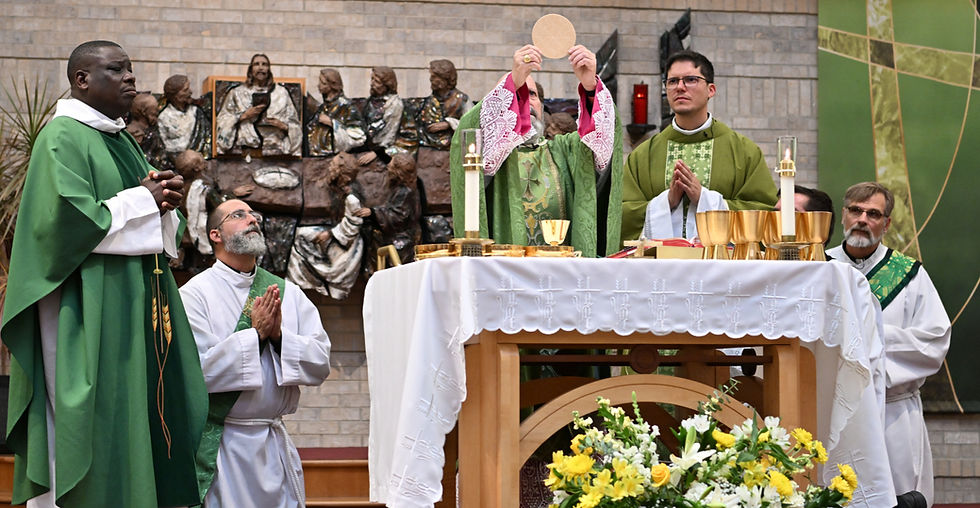Archbishop Samuel Aquila raising up a host for Mass