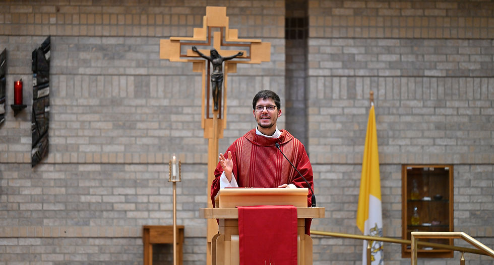Father Felipe Colombo giving a homily in a red chasible