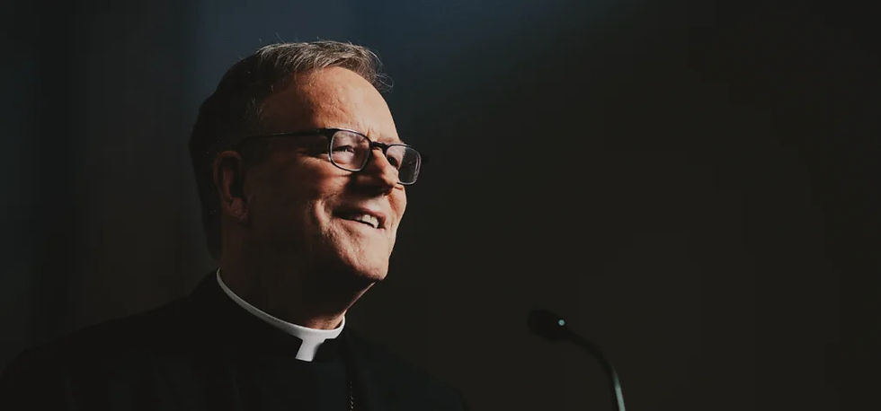 Bishop Robert Barron against a black wall